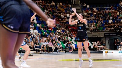 UC Capitals player shooting the basketball while a defender closes in.