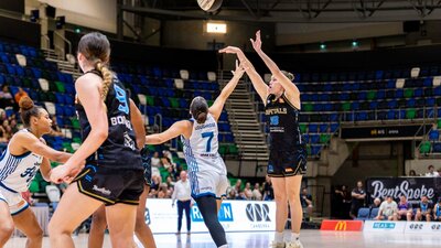 UC Capitals player shooting the basketball while a defender closes in.