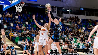 UC Capitals player driving to the basket for a layup during a WNBL game against Townsville Fire.