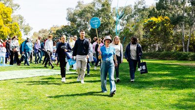 A campus tour group walking across the university lawns
