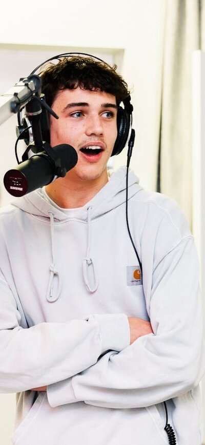Prospective male university student in front of the microphone in the UCFM studio
