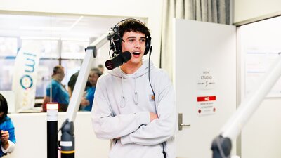 Prospective male university student in front of the microphone in the UCFM studio