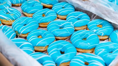 A box of blue-iced donuts representing those that wuill be free for attendees on the day