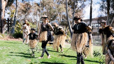 Indigenous dancers performing Welcome to Country on the concourse