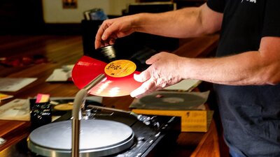 Vinyl Lounge Reconciliation Week 2025 Close up of man preparing to play vinyl