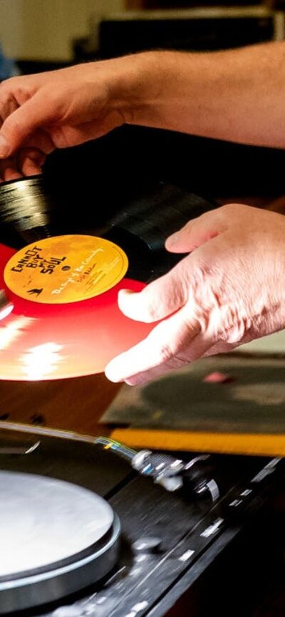 Close up of man preparing to play vinyl