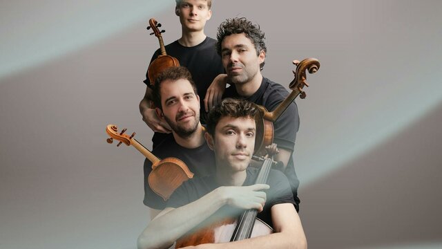 The four members of the Vision String Quartet holding their instruments