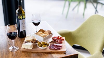 Shaw Estate grazing platter and red wine on a table from Shaw Estate Wines Canberra