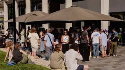 People enjoying Frenzy 2024 tasting wine and sharing community