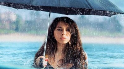 When The Rain Stops Falling by Andrew Bovell Woman standing in the sea with an umbrella (in the rain)