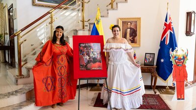 Two women in traditional dress posing in the lobby for Windows to the World