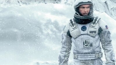 Man wearing a space suit in snow surroundings