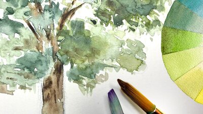 A watercolour painting of a eucalupt tree, next to brushes and a colour wheel