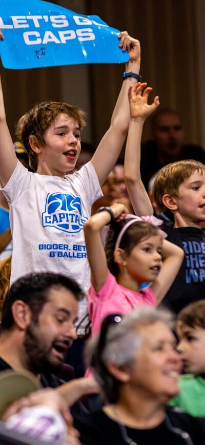 UC Capitals fans in the stands cheering for their team