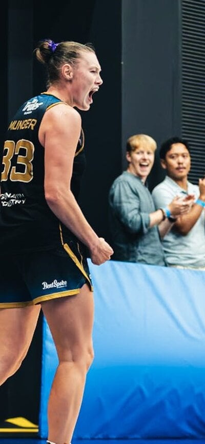 Two basketball players cheer for each other after making a tough shot.