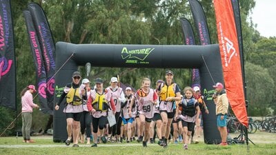 teams are running to their kayaks at the Women Only Adventure Race