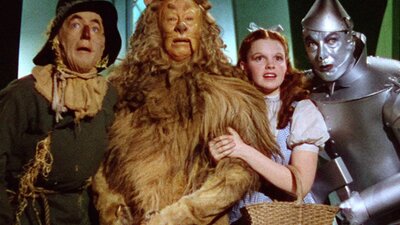 The Wizard of Oz (1939) Straw man, lion, young woman and a tin man in a row
