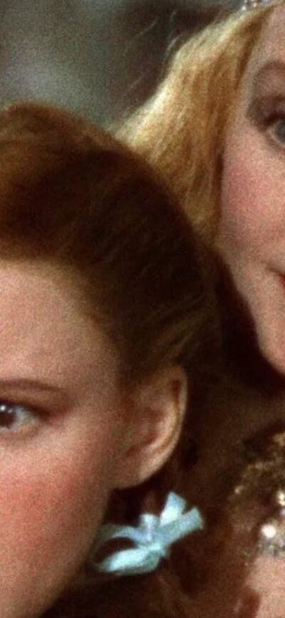 The Wizard of Oz (1939( Young girl stares scared with a fairy leaning behind her