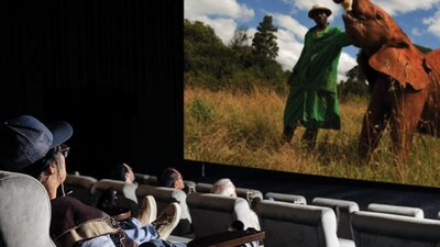Familes watching a documantary on the the IMAX screen