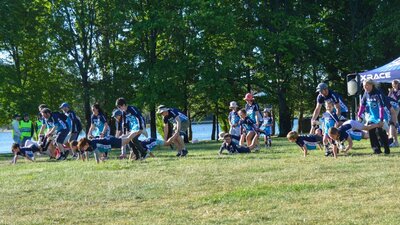 Group of parent-child duos competing in XRACE, with Lake Burley Griffin in the background